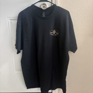 Black t-shirt hanging on a door hook.